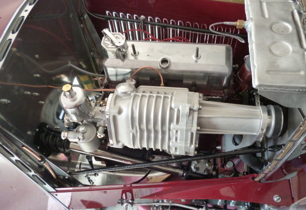 The XPAG engine in the chassis with a Mirage Garage supercharger mounted alongside it.