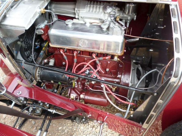 The engine bay seen from above: the MG rocker cover and red HT leads, with the supercharger across the top of the frame.