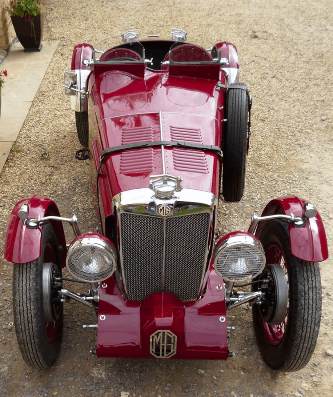 High front three-quarter view looking down over the radiator grille, headlamps and bonnet.