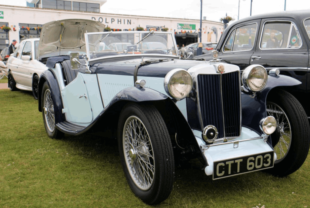 A pale blue 1937 MG TA in standard factory bodywork, registration CTT 603, at a show.